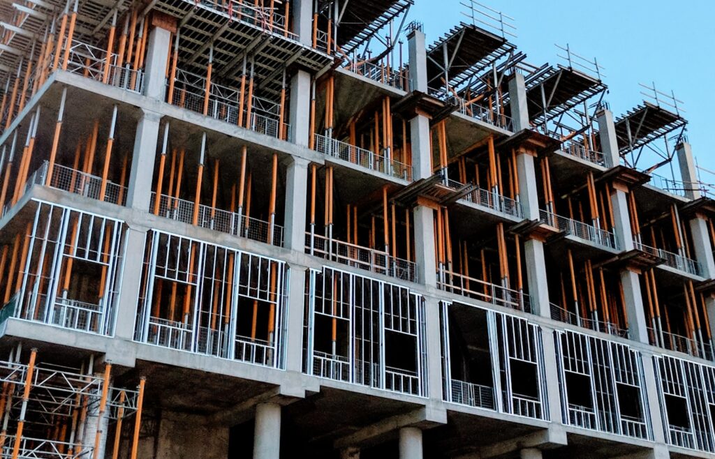 Concrete residential tower under construction, showing formwork and balcony slabs